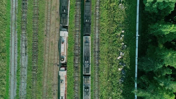 Aerial Top Down Shot of an Abandoned Rusty Locomotives and Old Railways