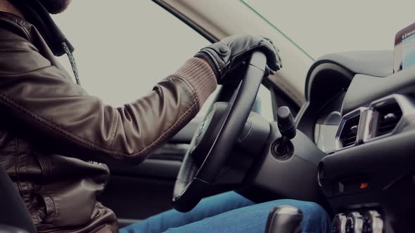 Male Driver Turning Steering Wheel In Car. Man Travelling On Winter Automobile Road. Steering Wheels