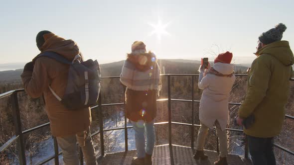 Tourists Taking Photos Of Winter Mountains