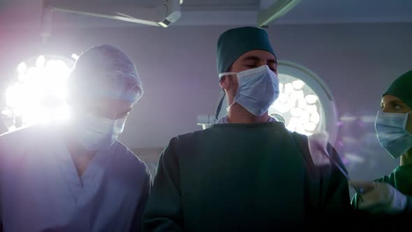 Medical team performing operation in operating room