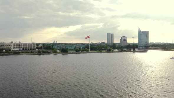 Flag of Latvia on the Shore of Daugava River in Riga Beautiful Drone Footage