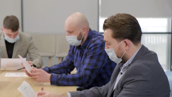 Business People Having a Meeting Working in the Office Wearing Medical Mask