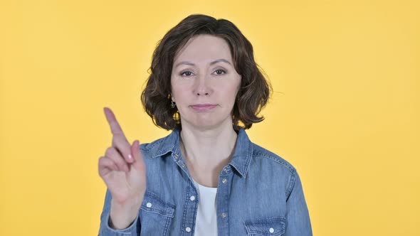 No, Finger Sign By Old Woman on Yellow Background