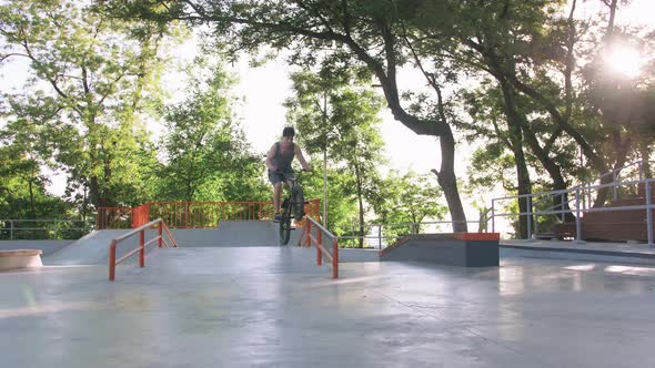 BMX Rider Doing Tricks in Cocncrete Skatepark Slow Motion