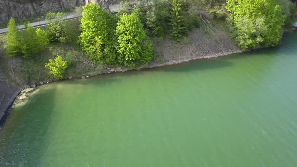 Aerial Panning of Reservoir structure with trees by the water front