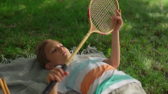 Upset Little Boy Lying Blanket in Park