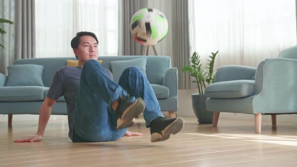 Asian Man Sitting And Show Skill With Soccer Ball In Living Room, Soccer Freestyle