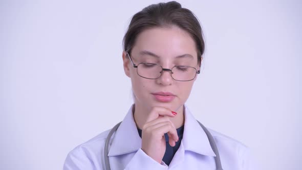 Face of Serious Young Woman Doctor Thinking and Looking Down
