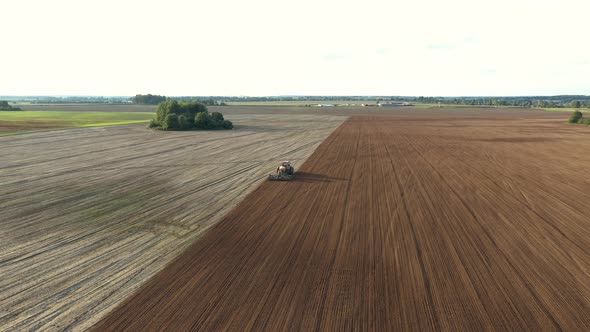 Tractor Planting Seeds Of Grain Crops In Agricultural Field Aerial Fly Forward