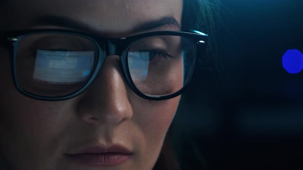 Close Up of Tired Woman Working at Night on Laptop Girl in Eye Glasses with Reflections Overworking