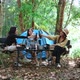 Young women sitting and drink beverage front of camping tent - VideoHive Item for Sale