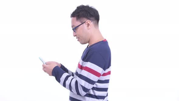 Profile View of Japanese Hipster Man with Phone Being Taken Away