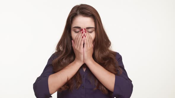 Beautiful Caucasian Female with Long Brown Hair and Dark Blue Shirt Yawning Stretching Standing on