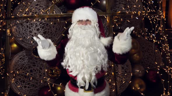 Funny Santa Claus is Talking to the Camera Wishing Merry Christmas and Happy New Year