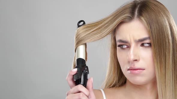 Angry Woman Using Curling Iron