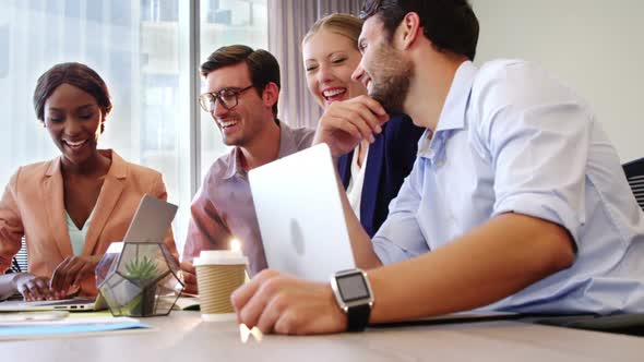 Businesspeople interacting and giving high five to each other