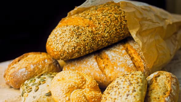 Different Kinds of Fresh Bread on Wooden Table