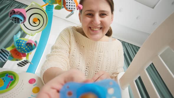 POV of Mother Giving Pacifier to Her Little Baby Lying in Bed