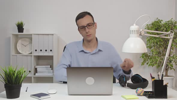 Man Working on Laptop Computer and Listening To Music at Desk in Home Office Slow Motion Close Up