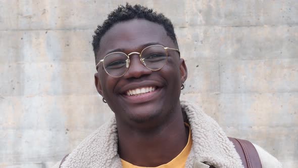 Young African American Man with Glasses Looking at Camera and Smiling