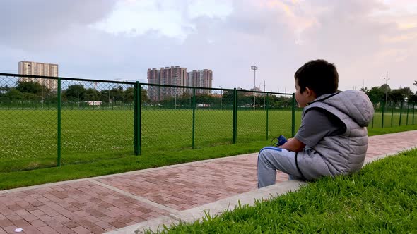 Boy sitting in the park