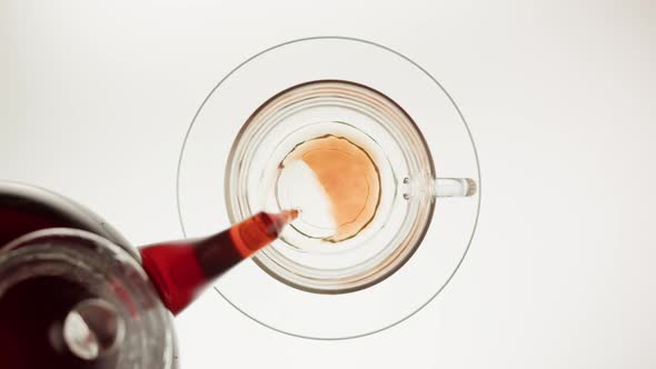 Pouring Black Tea in Cup Top View