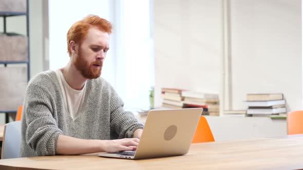 Man Thinking and Working on Laptop