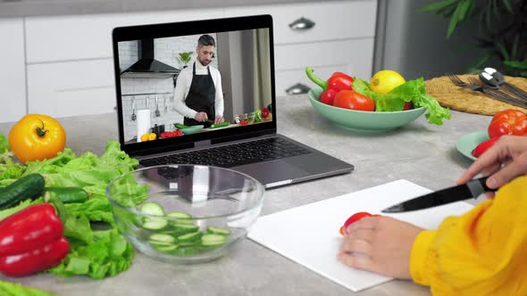 Man Food Blogger in Laptop Screen Tells Teaches Housewife Remote Cooking Course