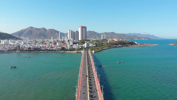 Shooting Aerial Unmanned Flight From Top View of the City Bridge with Cars and Motorbikes Against