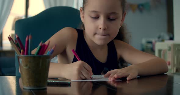 Happy Little Girl or Cute Primary Child School Child of 7-8 Years Old at Home Relaxing Sits in House