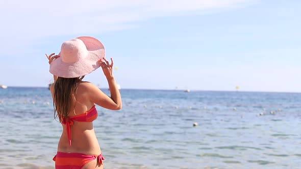 Beautiful Woman in Bikini Sunbathing By the Sea