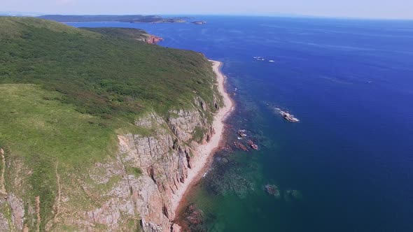 View From a Drone of the Coastline with a Rocky Coast Island of Shkot