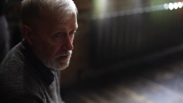 Top View of Close-up Face of Gray-haired Mature Man Talking and Listening During Communication.