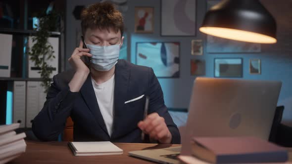 Portrait of Young Asian Man Wearing Medical Mask Calling on Phone Using Video Call Lecture Remote