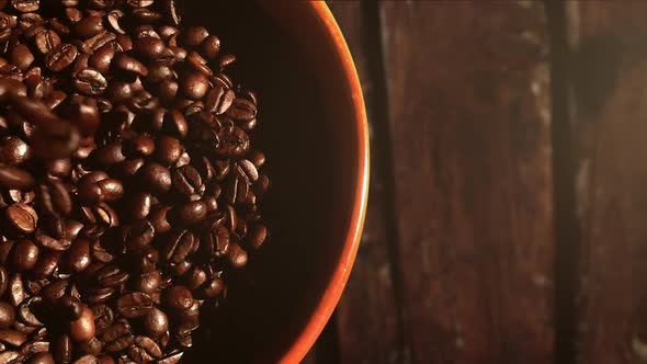 Dropping coffee beans into a bowl. Dolly slow motion shot