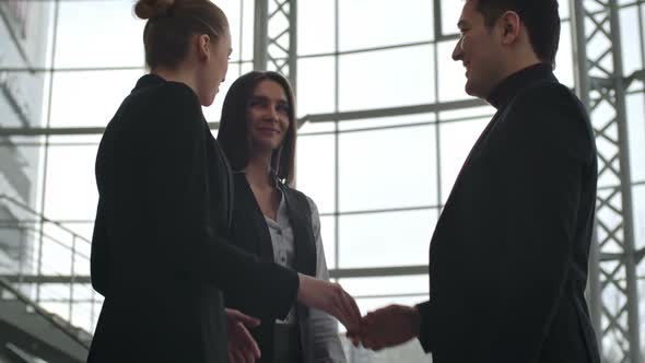 Businessman Greeting Female Colleagues
