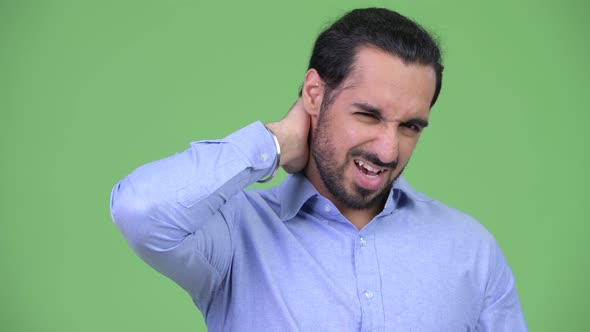 Young Stressed Bearded Indian Businessman Having Neck Pain