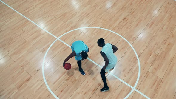 Top View of Two African Ethnicity Players Practicing Basketball in the Gym