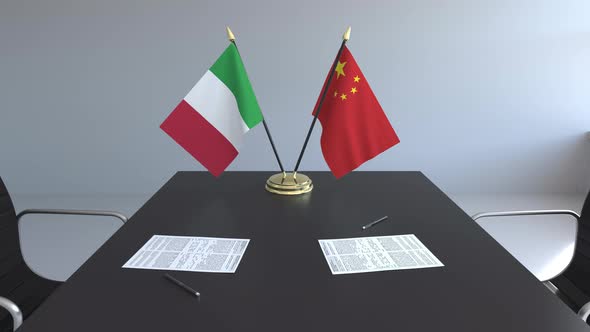 Flags of Italy and China on the Table