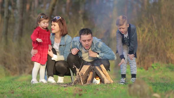 Family on Vacation for a Picnic with a Fire