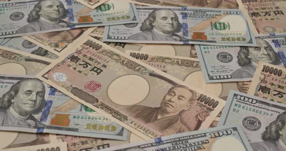 Stack of American USD and Japanese Yen banknote