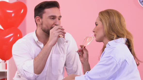 Handsome Man Drinking Wine and Kissing Beautiful Woman, Romantic Atmosphere