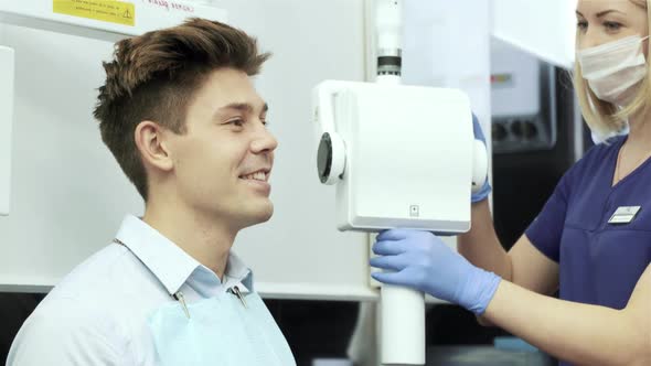 Dentist Taking Picture on Xray Machine