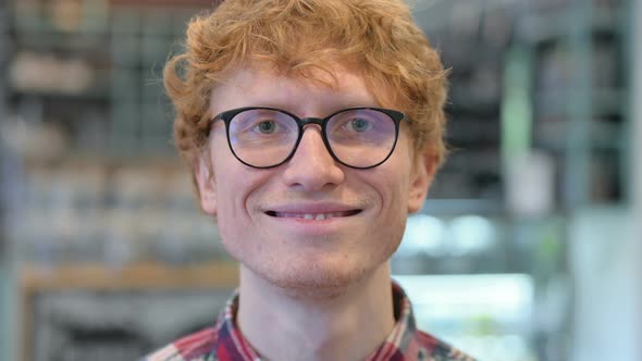 Close Up of Young Redhead Man Smiling at the Camera 