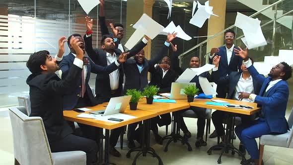 Success International Group of Ten Excited Young Business Team Throwing Away Papers and Hands Shake