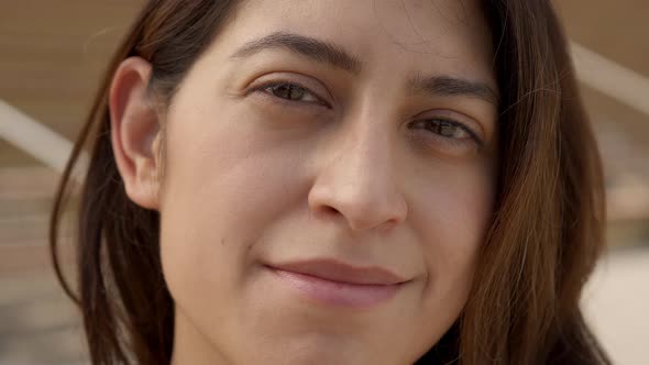 Outdoor Portrait of a Latina Woman Looking at Smiling Camera