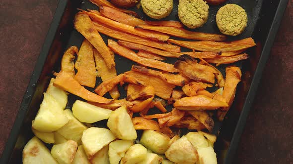 Baked Vegetables and Falafel. Potatoes, Carrot and Sweet Potatoes on Metal Tray.