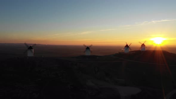 Aerial view of windmills in the countryside in Spain at sunrise