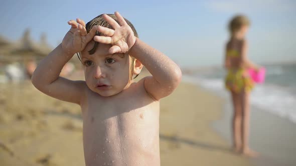 Cute Boy Trembling on Seaside