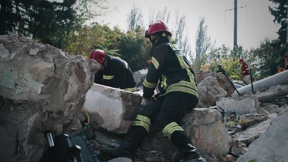 Emergency Service Workers on Ruins of Building